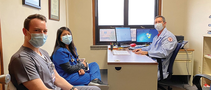Dr. Kasper in his office with third-year medical students Garret Waterstradt and Gabriela Gonzalez-Cantoran