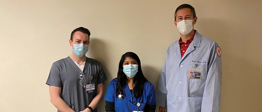 Dr. Kasper in his office with third-year medical students Garret Waterstradt and Gabriela Gonzalez-Cantoran