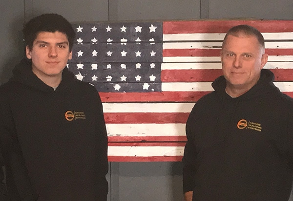 Jake Beach (left) and Steve Beach at Savage Building Systems in Varna. Steve Beach owns the business; son Jake works on one of the crews