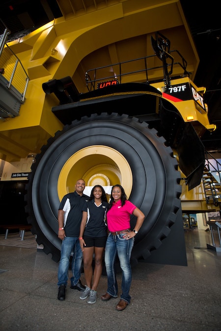 Posing in front of the 14-foot tall Cat® 797 Mining Truck tires.