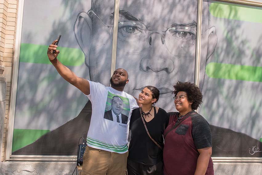 Artists Kevin Bradford, Brenda Gentry and Hannah Offutt with Bradford's portrait of Dr. Romeo B. Garrett 