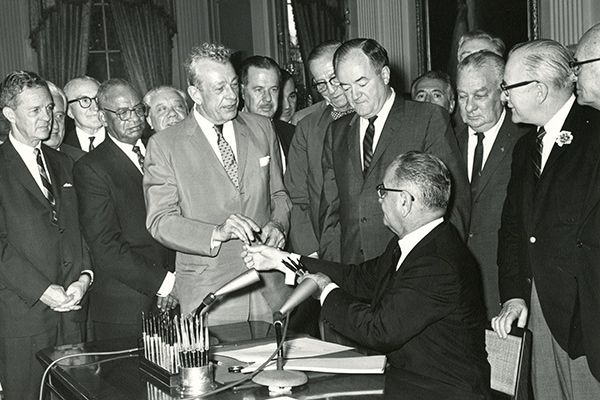 President Lyndon B. Johnson signs the Voting Rights Act of 1965