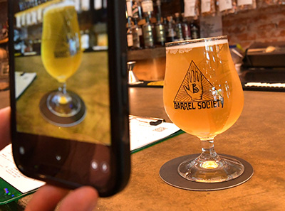 A photo being taken of a glass of beer