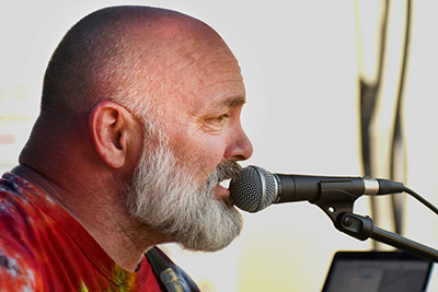 Photo of a man singing into a microphone