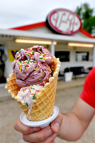 A waffle cone and ice cream with sprinkles