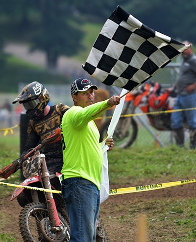 Man waving checkered lfag