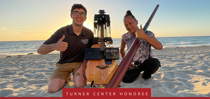 Turner Center Nominee: a man and woman sitting on a beach with a guitar and a Didgeridoo