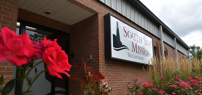 South Side Mission Building with a rose bush