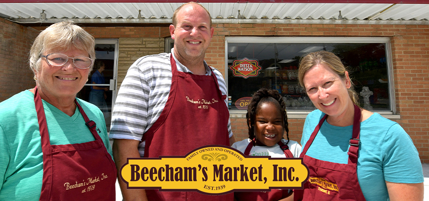 Family standing in front of a building - Beecham's Market, Inc.