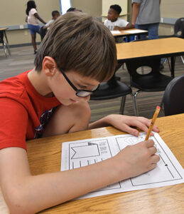 Young Child at School desk working on School Work