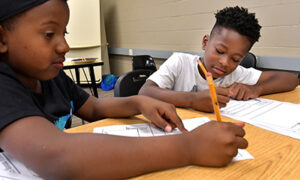 Young Children at School desk working on School Work