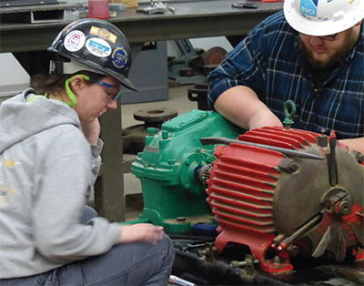 men working on a motor