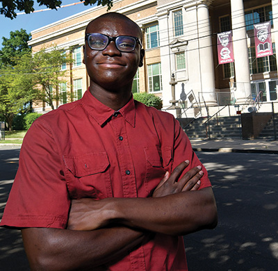 Student in red shirt standing in front of Peoria High