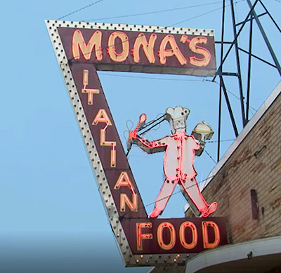 Neon restaurant sign with a chef