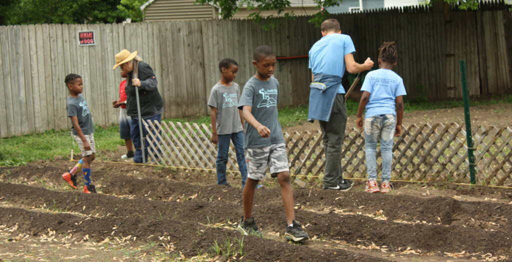 Children working on a neighborhood garden