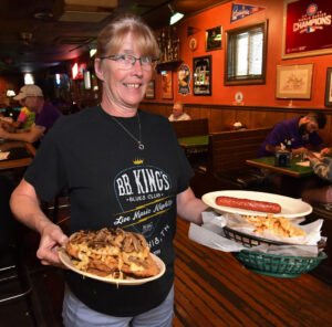 Waitress walking with plates of food