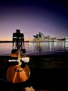 Self Playing Guitar with the Sydney Australia Opera House in the Background.