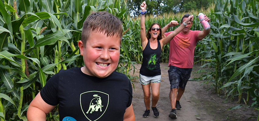 Eight-year old Justin Jeffries and his parents, Gina and Justin, find the exit after walking through the corn maze at Ackerman Family Farms in Morton