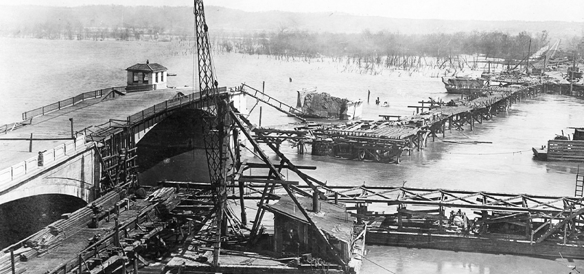 On May 1, 1909, piers broke under the Lower Free Bridge (also known as the Franklin Street Bridge), causing much of the span to tumble into the Illinois River. Photo courtesy of the Special Collections Center, Bradley University Library
