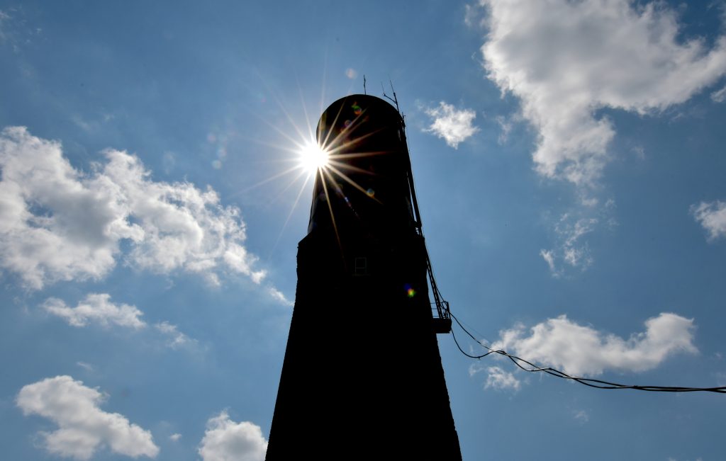 Havana water tower silhouetted over a blue sky with clouds