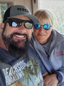 Emily and Rob Sharkey harvesting a corn field together on their family farm