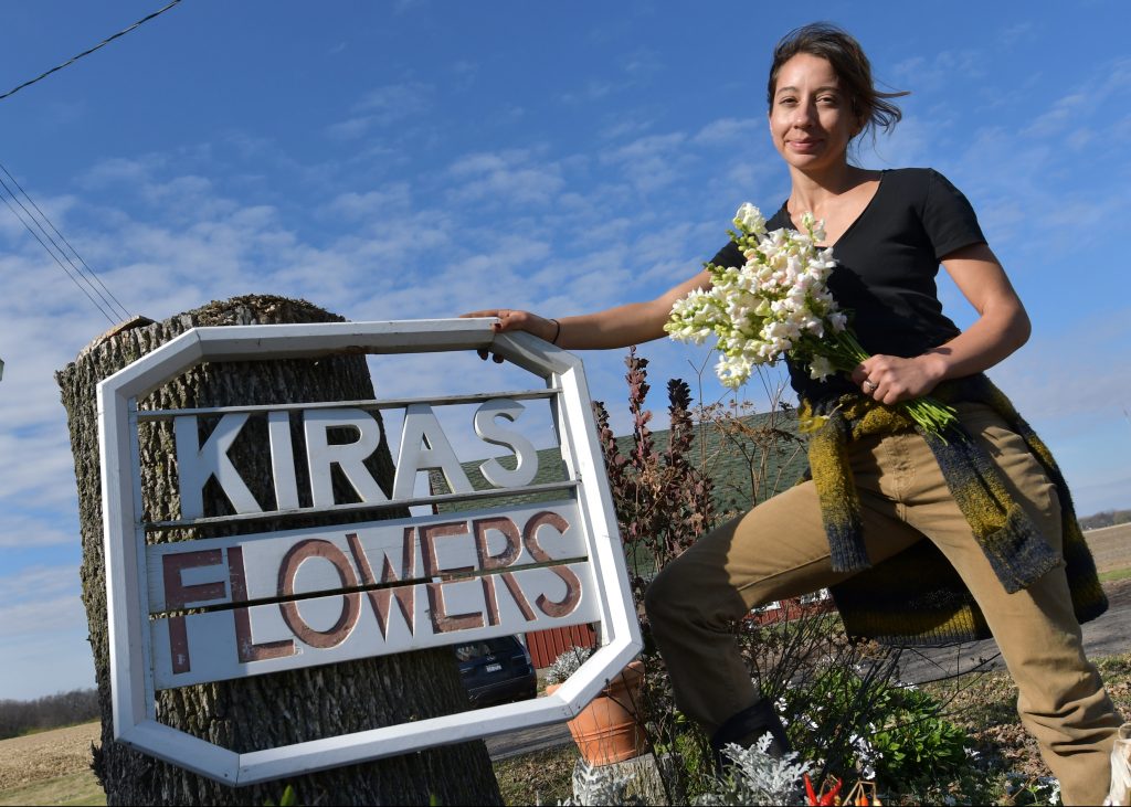 Farmer Anya Irons plants a variety of flowers at Ioerger Farms in Minonk.