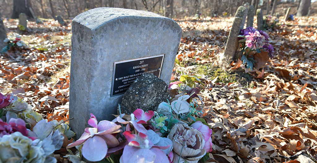 This headstone (photo by Ron Johnson) marks the grave of Rhoda Derry at the former Peoria State Hospital. It reads: ‘They built this place of asylum so that no other human would suffer as you. You taught us to love and feel compassion toward the less fortunate. May you find peace and warmth in God’s arms.’