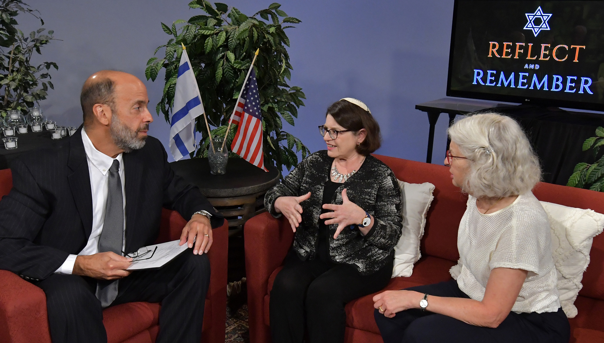 Bradley University professor and "Reflect and Remember" moderator Seth Katz, left, talks with the children of Holocaust survivors.