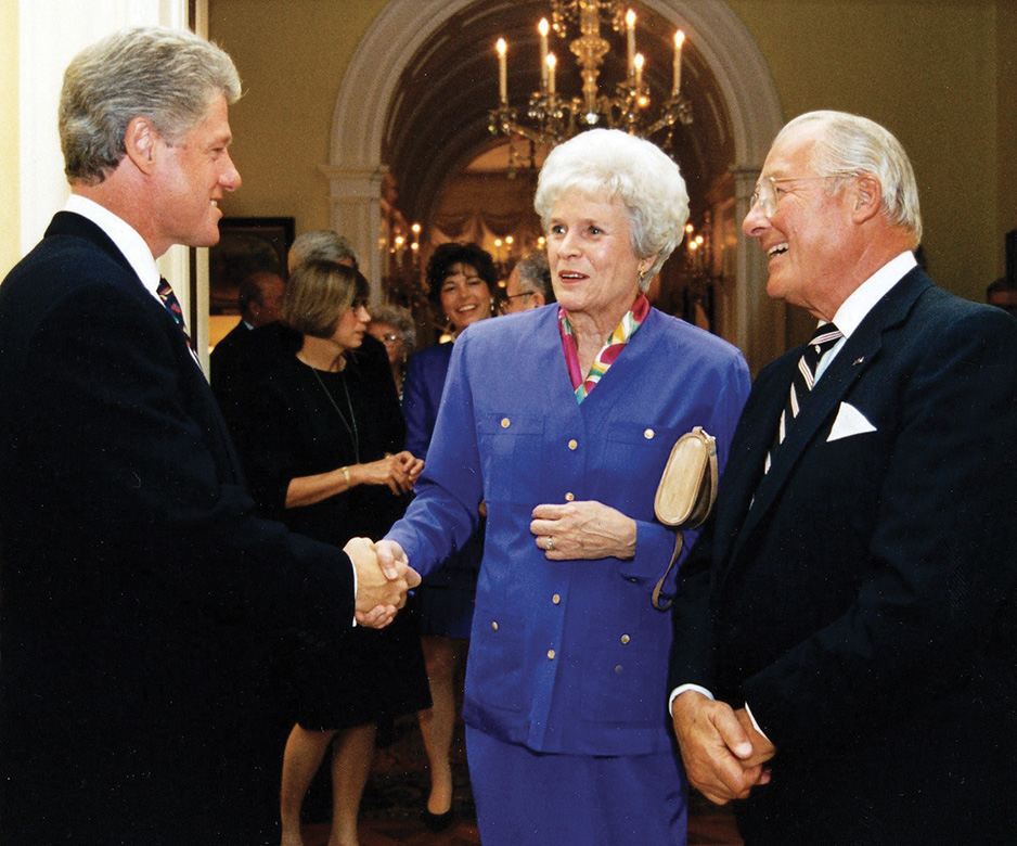 President Bill Clinton shakes hands with Corinne Michel as Bob Michel looks on