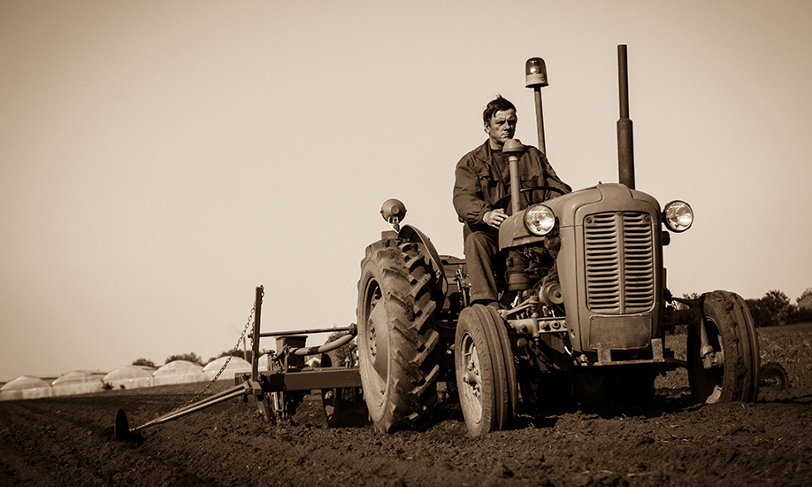 Vintage image of farmer on tractor