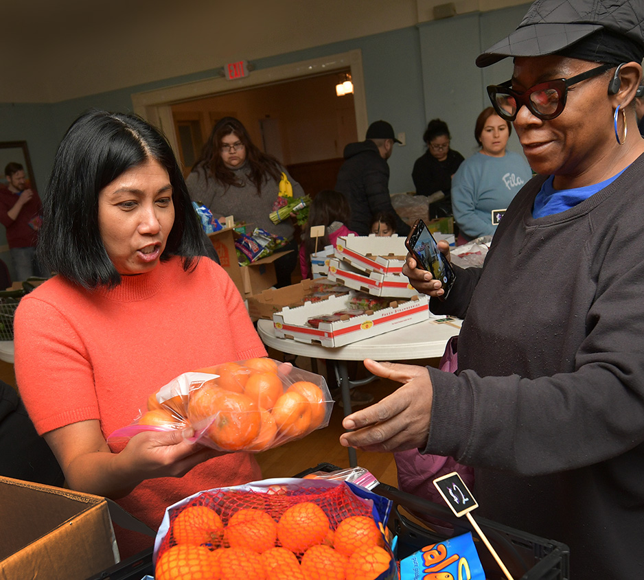 Julie Eliathamby, left, founder and executive director of Peoria Grown, works at her Market 309, a provider of fresh, affordable foods