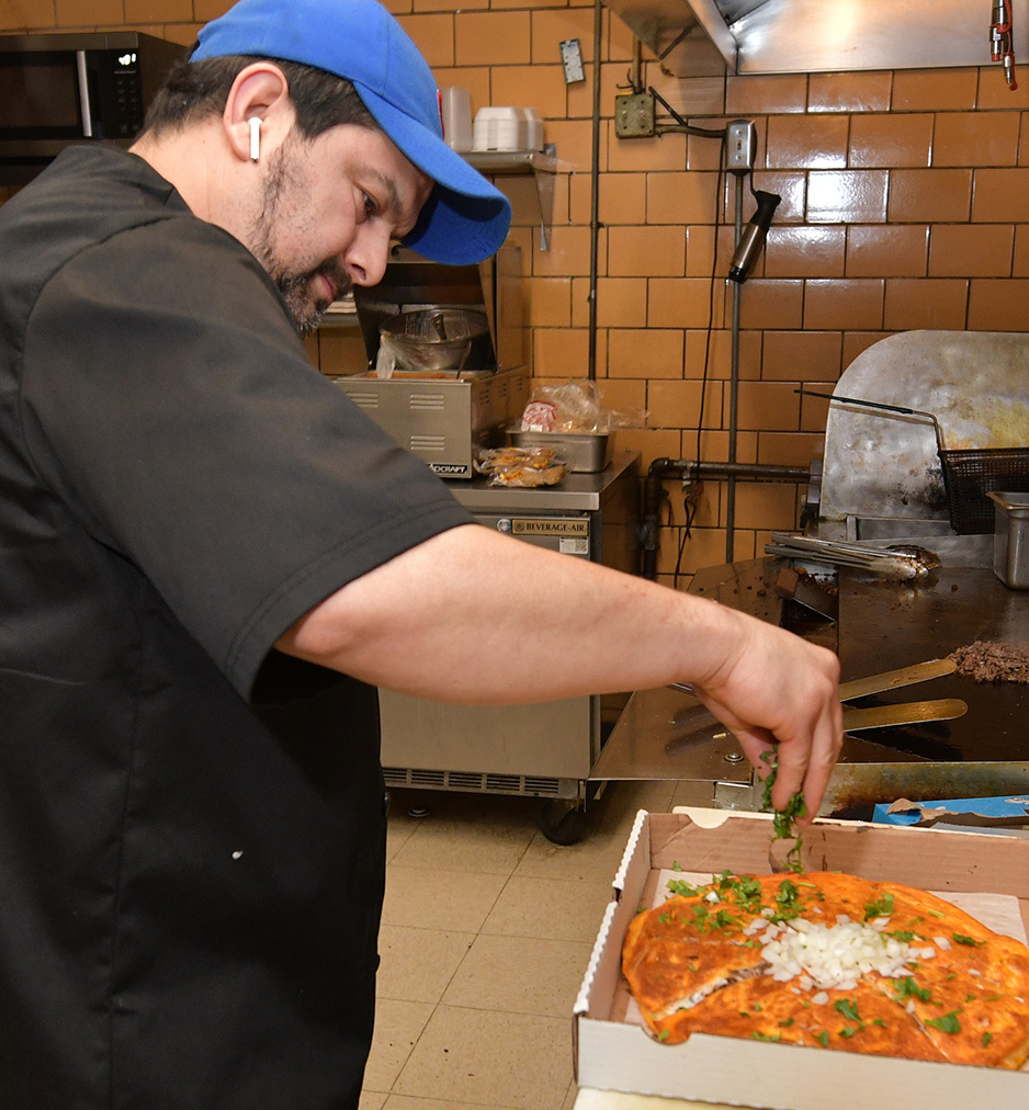 Chef Daniel Carachuri prepares a birria pizza