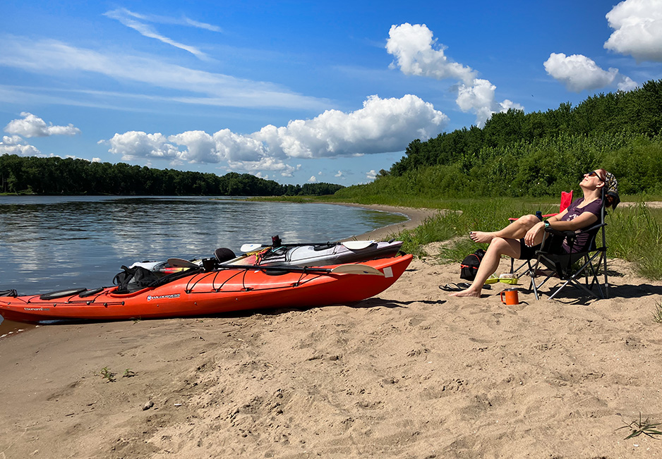 Angela Welchel enjoys breakfast on an Illinois River beach near Chillicothe (photo courtesy of Tom Cody)