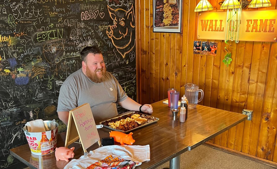 Bob Tieman of Peru is all smiles shortly before attempting Tony’s Butt Buster Food Challenge.