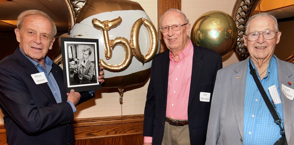 Bruce Brown, Jim Bateman and Les Bergsten at the 50th anniversary celebration of the 1973 Peoria City Council, of which they were all members. Brown is holding a photo of former Peoria Mayor Richard Carver