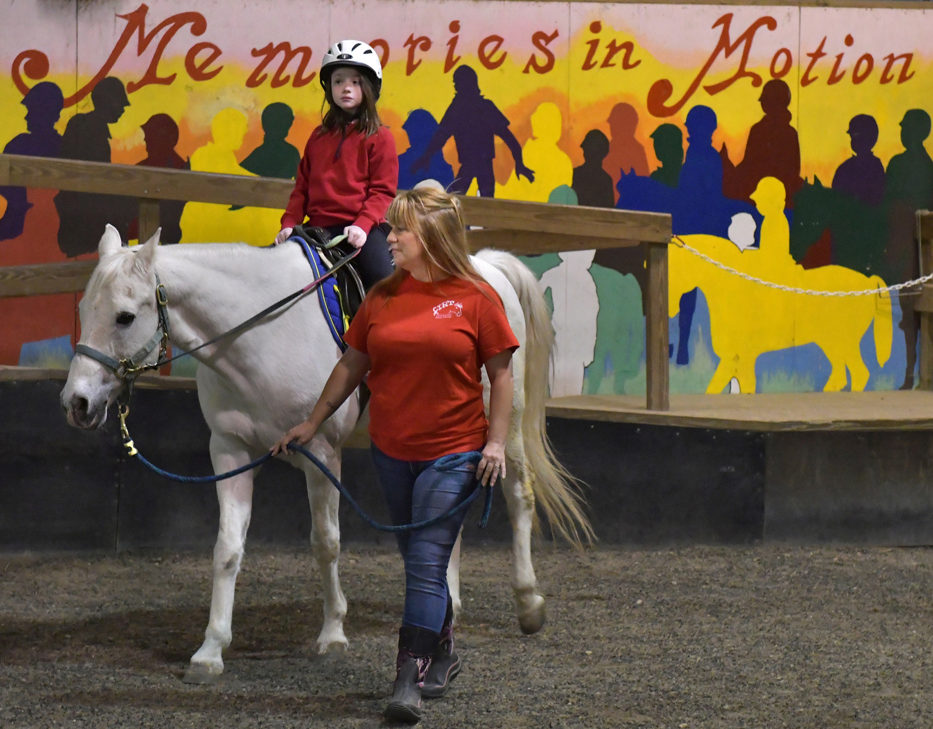 CIRT volunteer Stephani Erp works with 8-year old Andrea Frietsch as she learns to ride at Central Illinois Riding Therapy in East Peoria