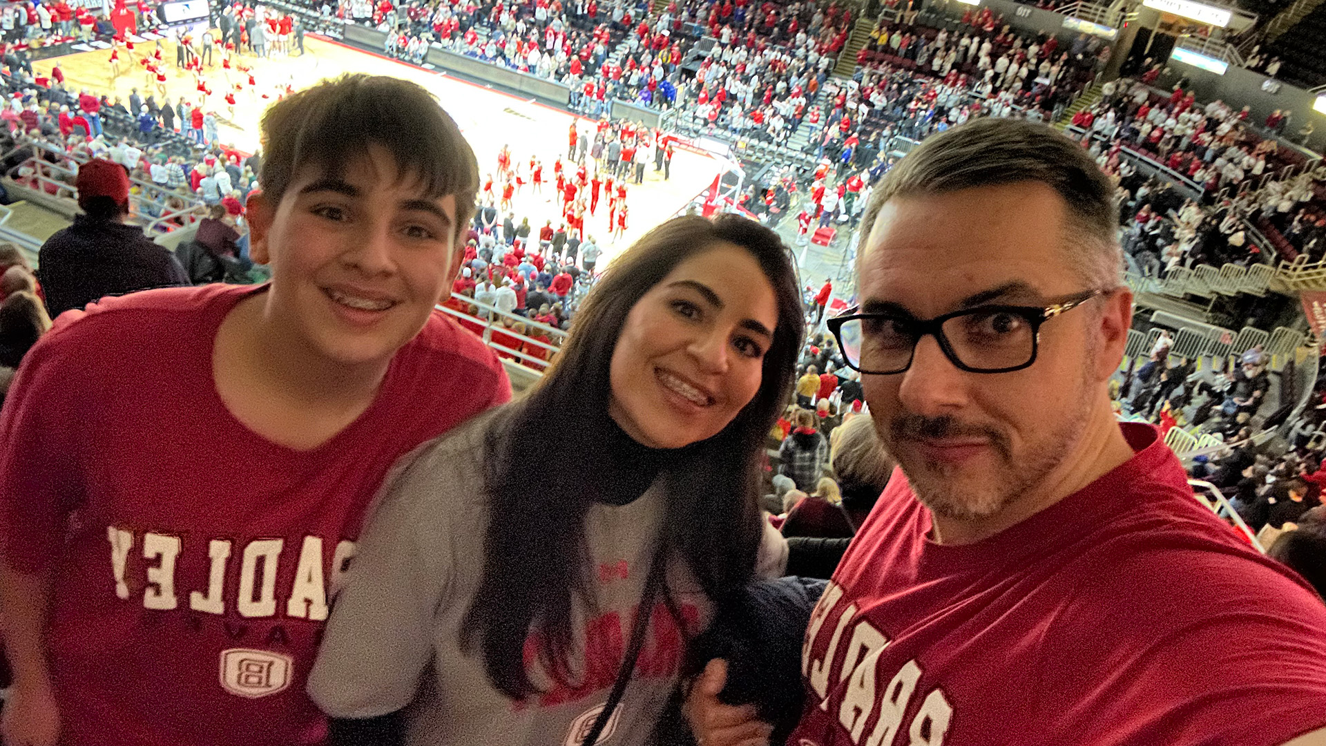 Alexandre Chequim, co-founder and CEO of DigiFarmz Smart Agriculture, attends a Bradley basketball game with his wife, Caroline, and son, Alex
