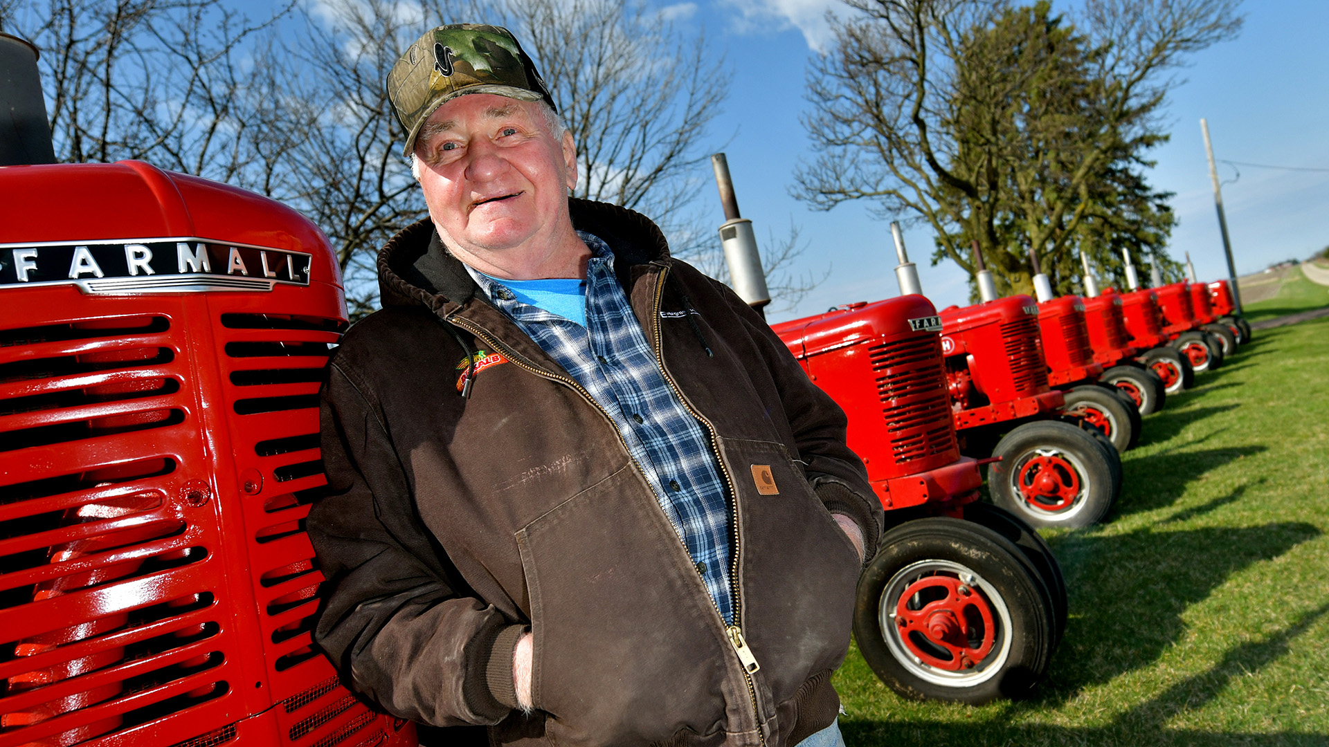 Ron Underwood and his extensive collection of Farmall tractors outside Eureka