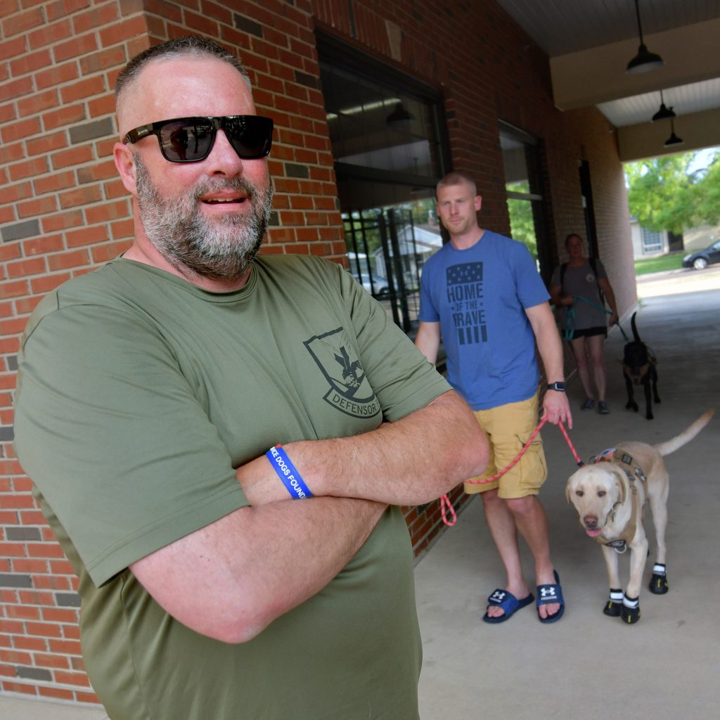 Corey James, founder of Freedom Paws Service Dogs, with trainer Adam Thompson