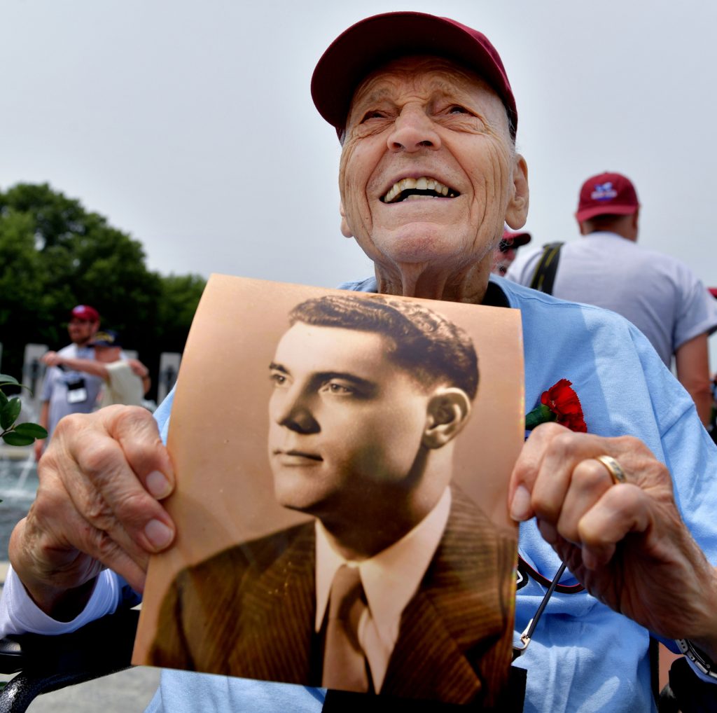 Al Purvis, 99, of Darien, Illinois, shows a younger side of himself to the crowd at the WWII Monument in Washington, D.C.