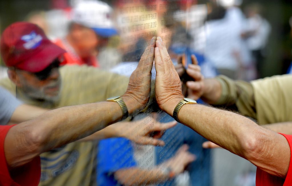 Reaching out to touch a fellow soldier's memory at the Vietnam Veterans Memorial in Washington, D.C.