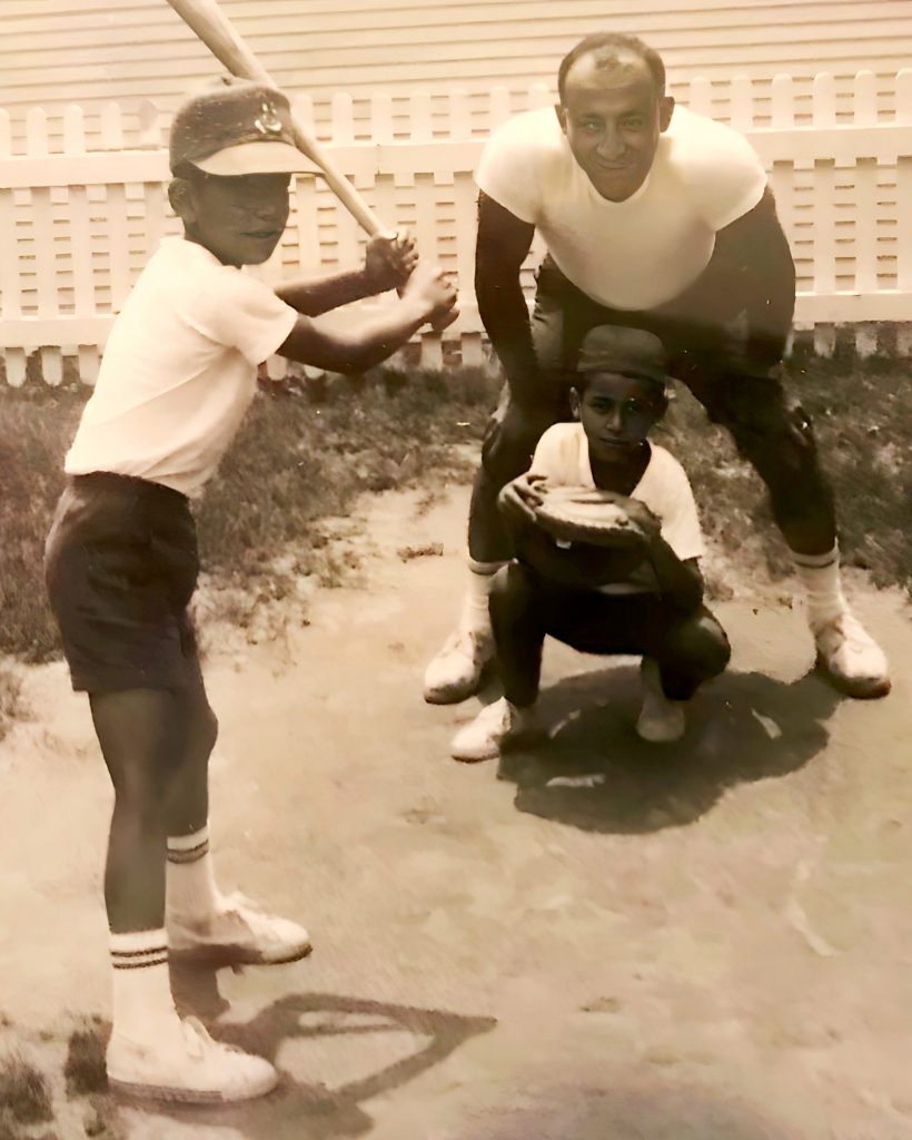 1965 snapshot: 7-year-old Jim Shadid steps to the plate. Catching is 6-year-old brother, Georgie. Dad George umpires