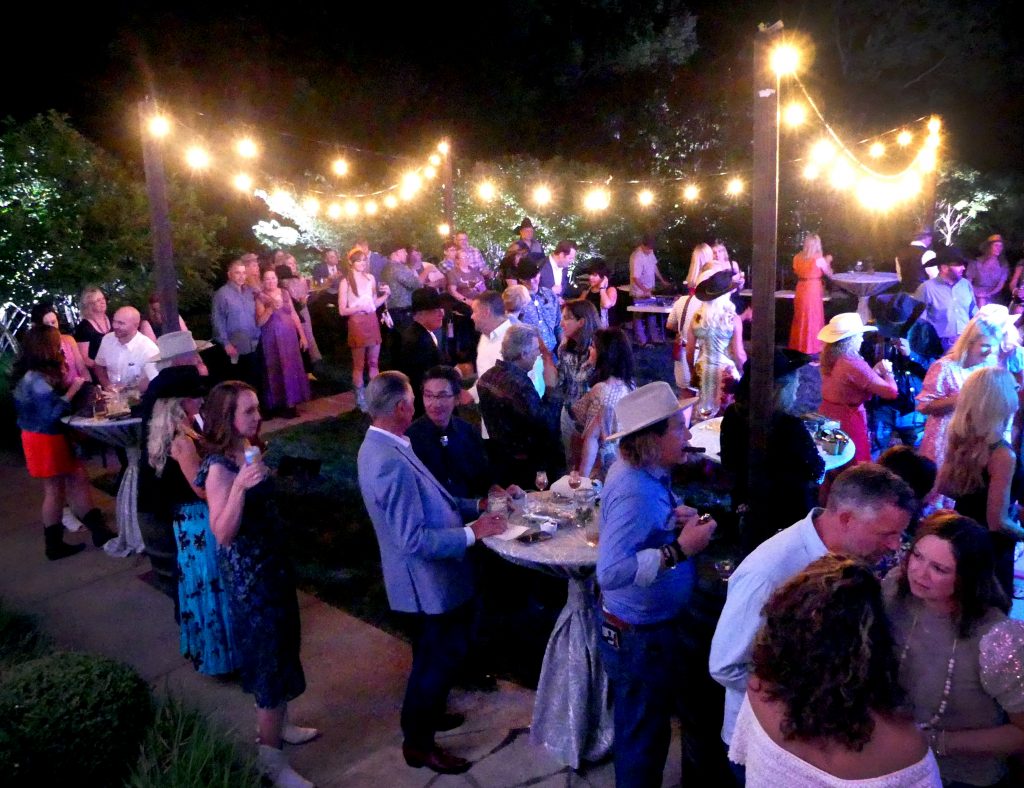 Party-goers enjoy the band and each other's company, all for some worthy charitable causes
