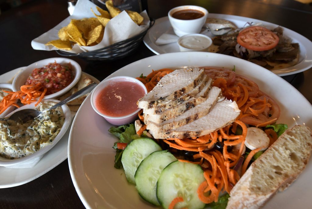 One_World_Cafe. A selection of dinner favorites, including an appetizer sampler and a psychedelic salad