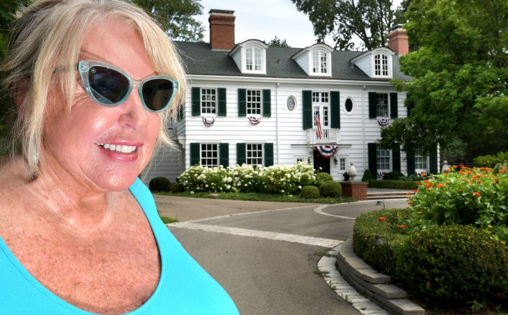 Jan Krouse, president of the Moss-Bradley Residential Association, walks by one of the mansions on Moss Avenue