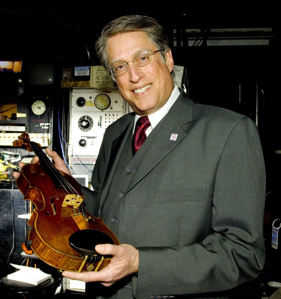 Jeffrey Huberman of Peoria poses with a violin once owned by ancestor Bronislaw Huberman