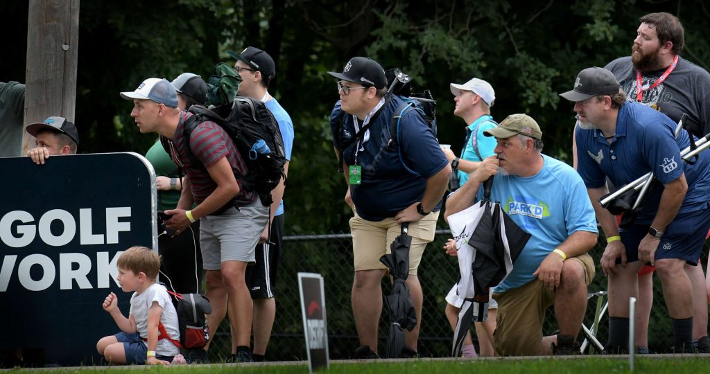 A crowd intensely watches the competition in the 2023 Ledgestone Open
