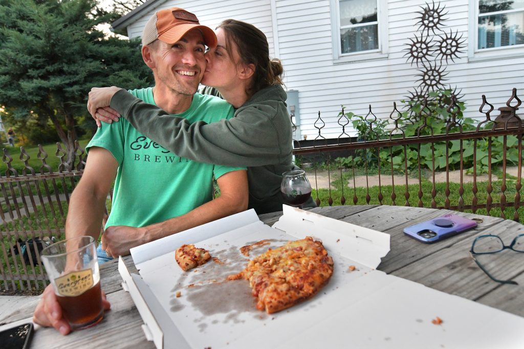 Adam Sommer, owner of Evergreen Farm Brewing, gets a kiss from wife Melissa Sommer after an evening of serving beer.