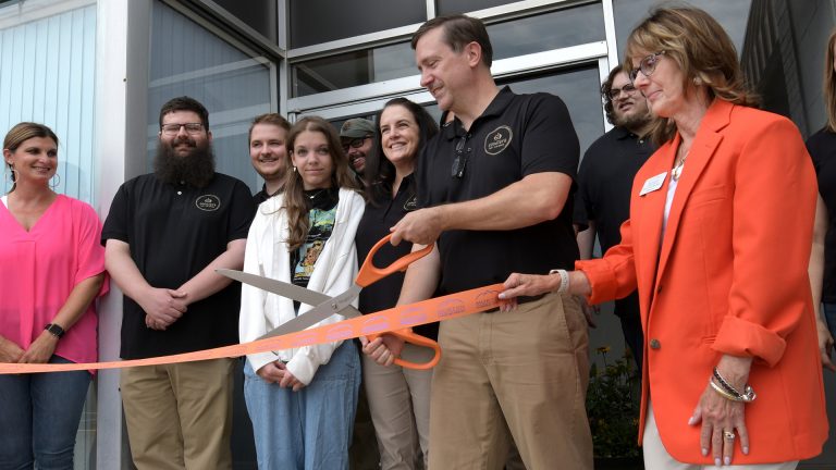 Matt Whitehall cuts the ribbon at the grand opening of GoodJava, a software company that won the Turner Center’s 2023 Startup of the Year