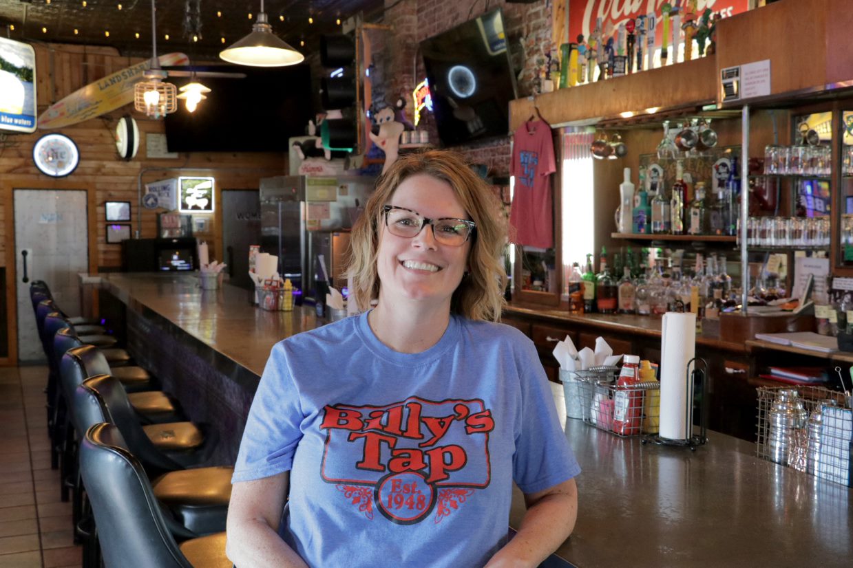 Owner Ashley Harper smiles inside Billy’s Tap in Canton. The oldest saloon in town, Billy’s offers a menu, atmosphere and meeting room that help draw visitors to Canton and boost the local economy